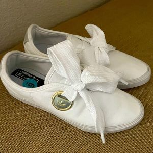 White adidas tennis shoe with bow
